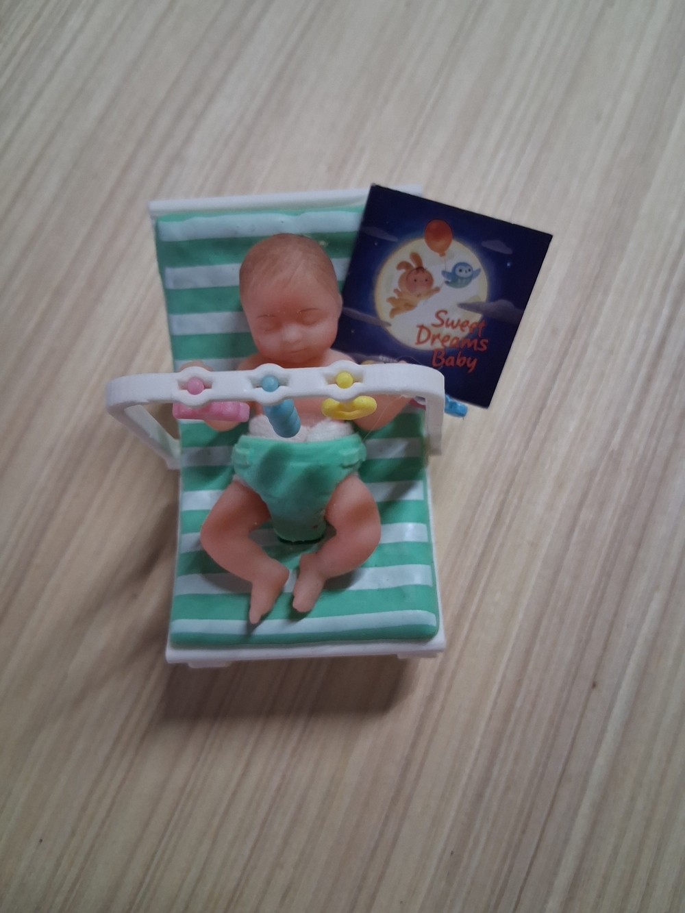 Mini Baby Doll on Striped Green Lounger